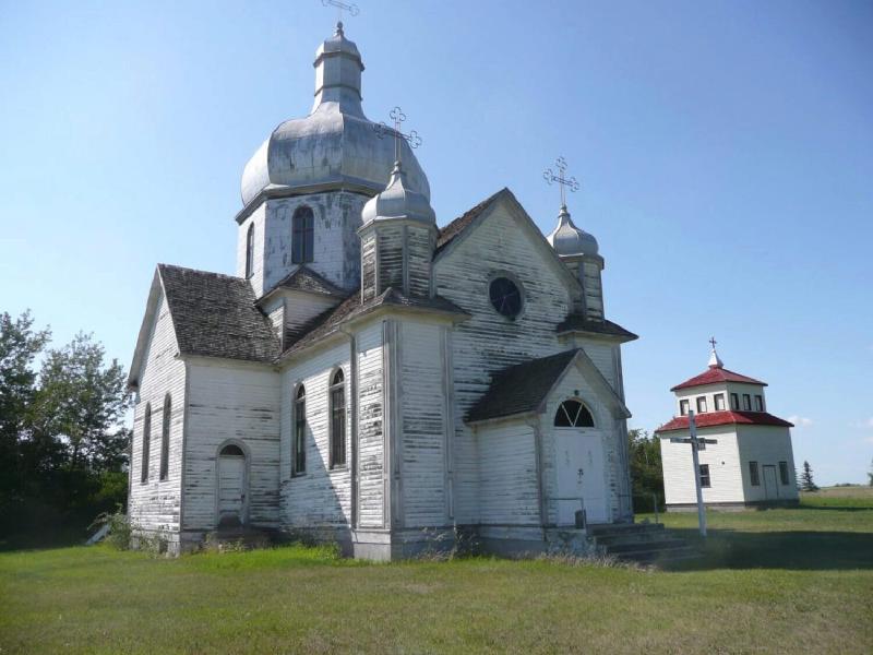 My July, 2008 photo (top cross cut off and all) shows the church in its orginal spot, fairly close to the belfry.