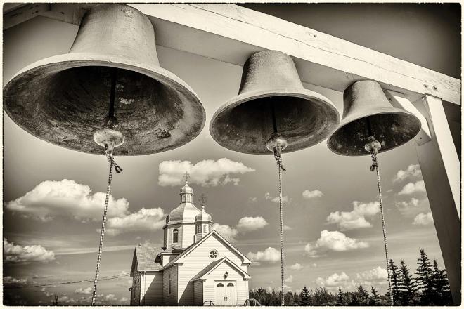 Instead of a belfry, three church bells are fastened to a post just west of the church. The bells were donated by one of the early pioneer families.